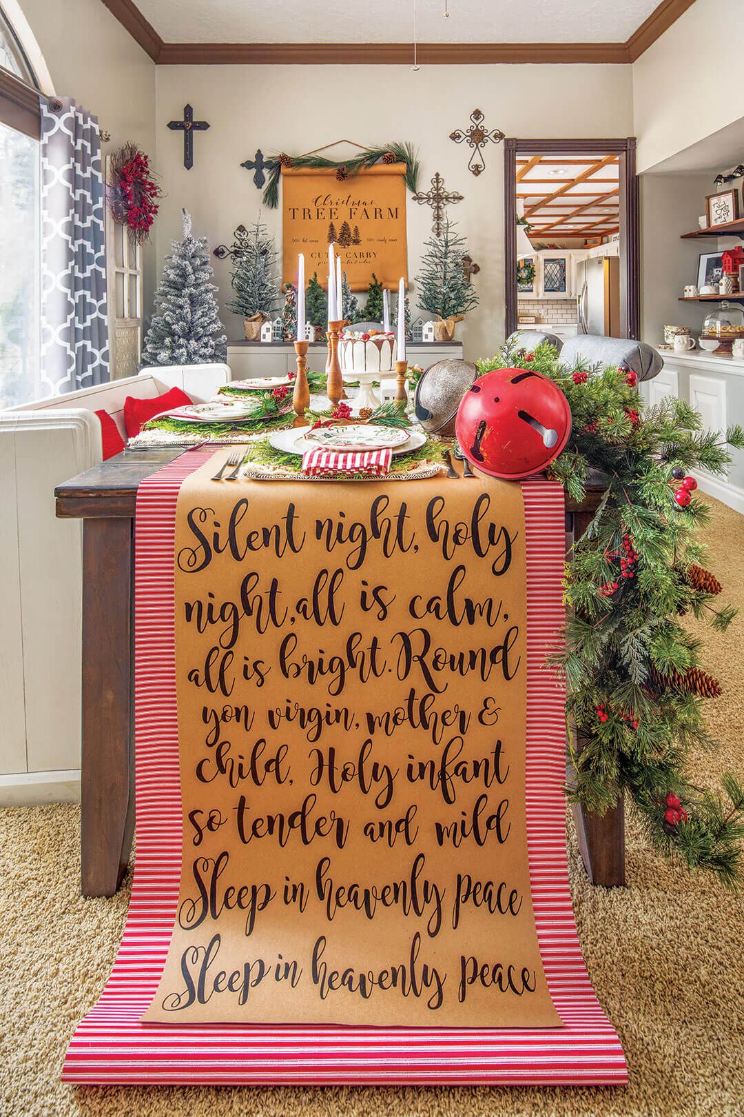 Dining table with Christmas garland, sign art and set table