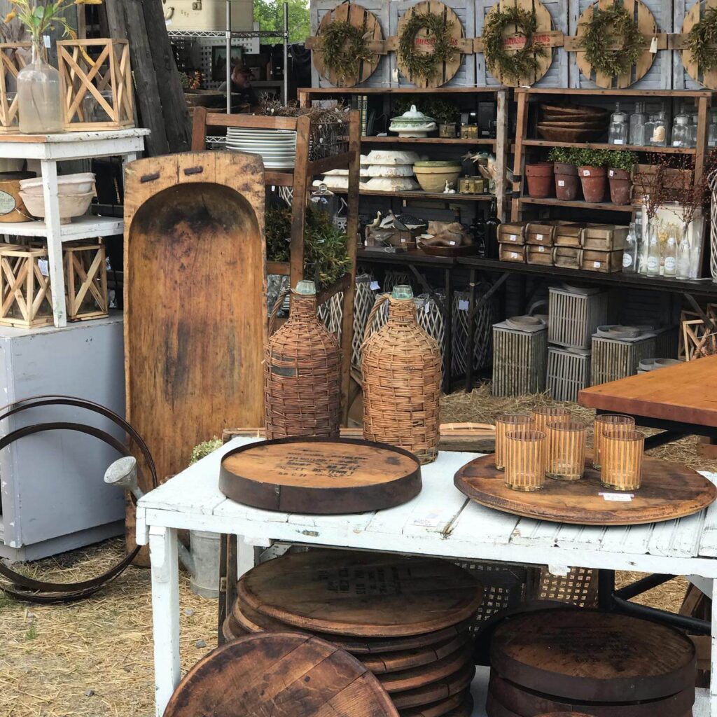 Corner of antiques shops with old wood items and jugs