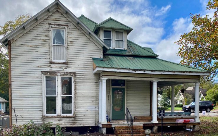 Exterior of home with old siding for before picture of farmhouse renovation