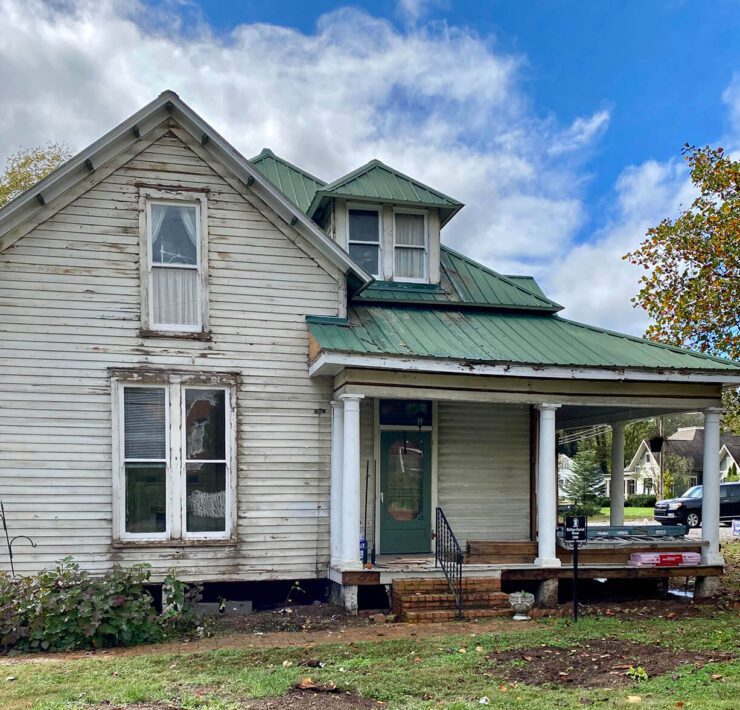 Exterior of home with old siding for before picture of farmhouse renovation