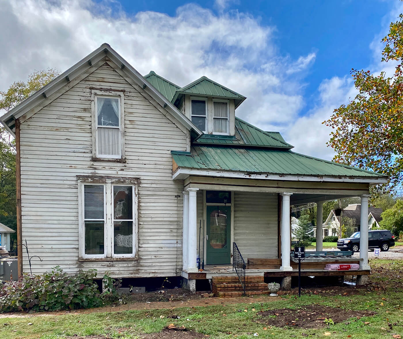 Exterior of home with old siding for before picture of farmhouse renovation