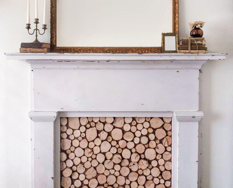 Faux fireplace with wood slice insert and mirror