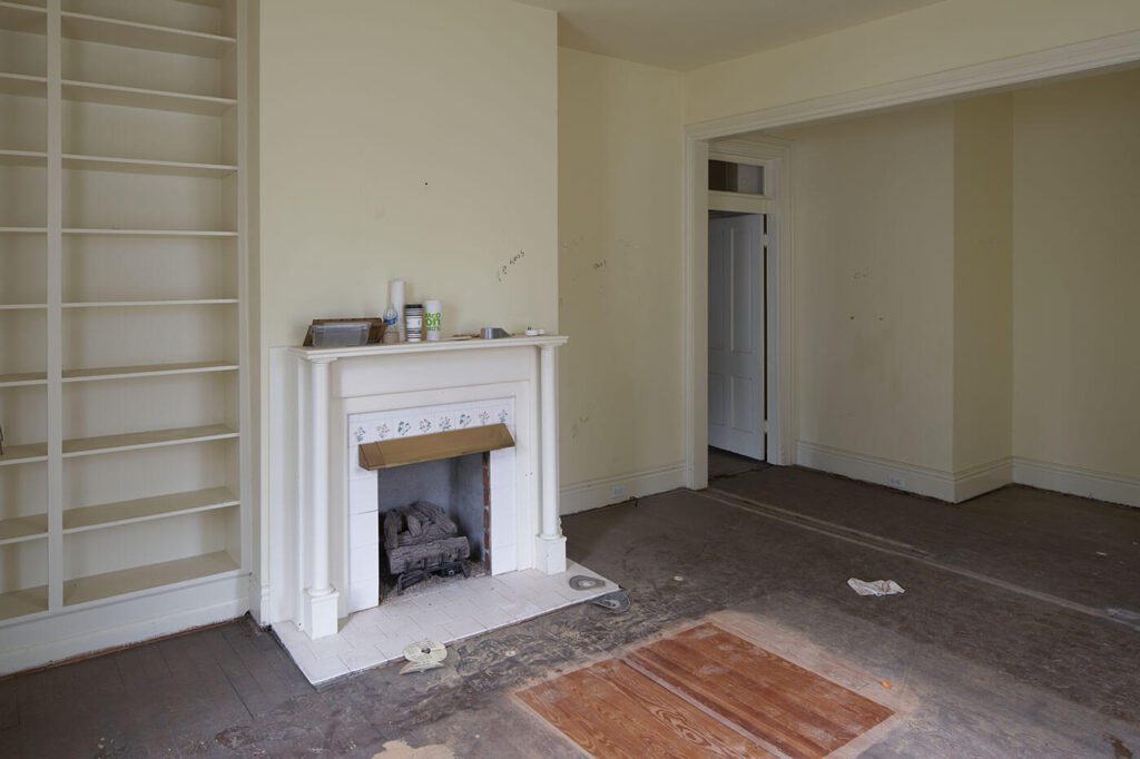 Living room before picture with old flooring and empty room