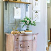 Vintage farmhouse style hallway with chippy dresser and vintage botanical prints on the wall