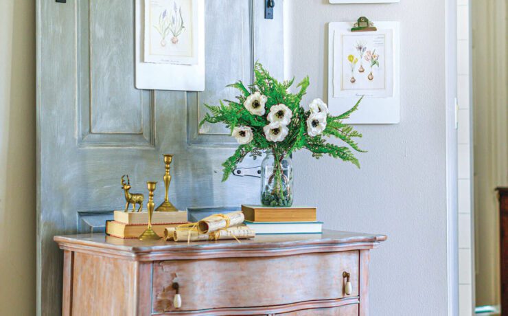 Vintage farmhouse style hallway with chippy dresser and vintage botanical prints on the wall