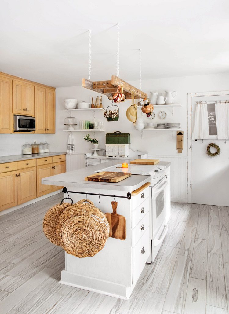 repurposed vintage ladder to hang pots and pans in neutral kitchen