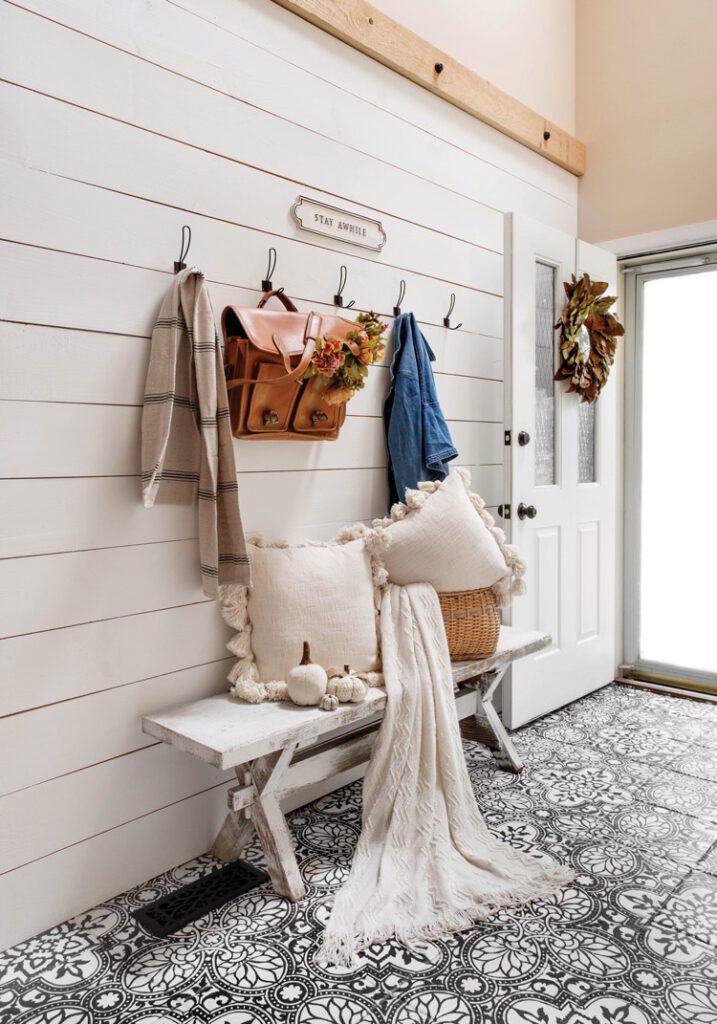 entryway with shiplap and patterned tile