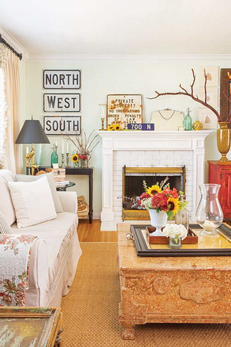 mixed furniture vintage signs and branches as decor in living room