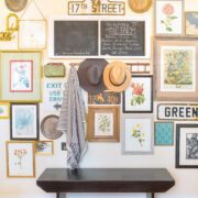 entryway gallery wall with framed prints and flea market signs