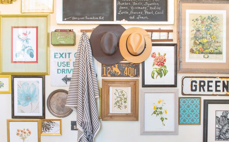 entryway gallery wall with framed prints and flea market signs