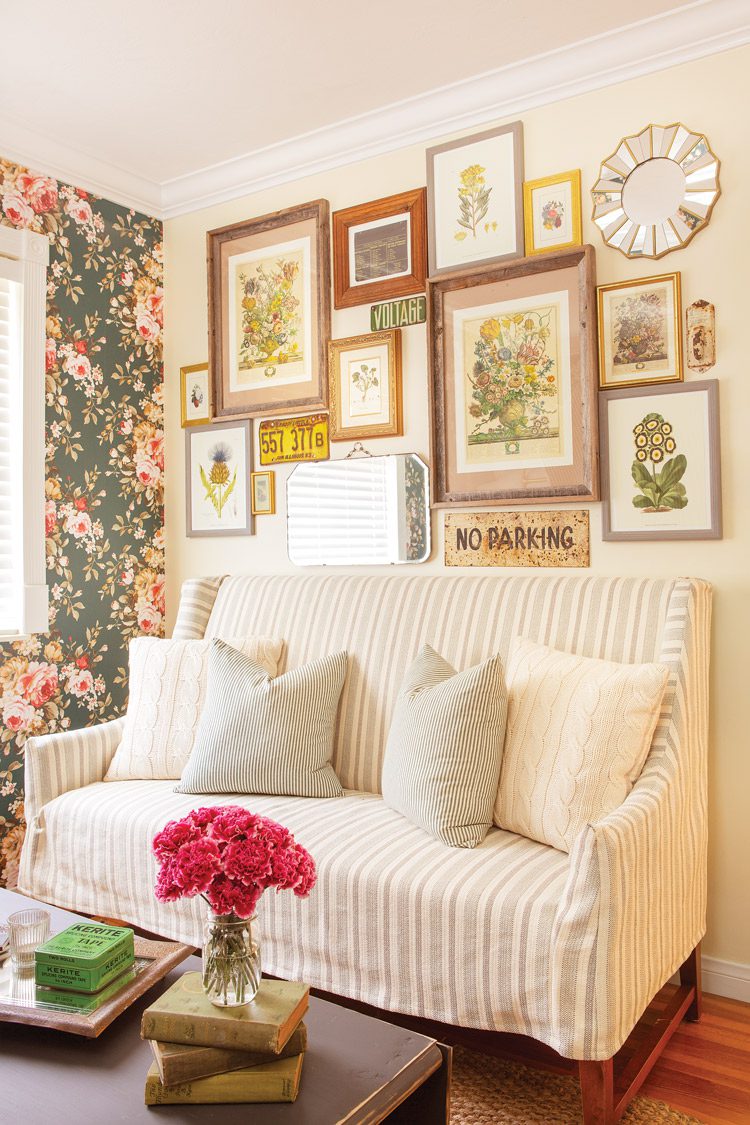 gallery wall with various floral prints and vintage signs