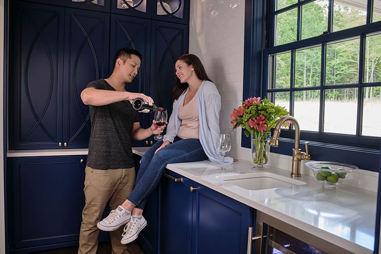 Couple in kitchen with a glass of wine