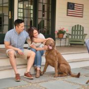 Couple sitting on patio with dog