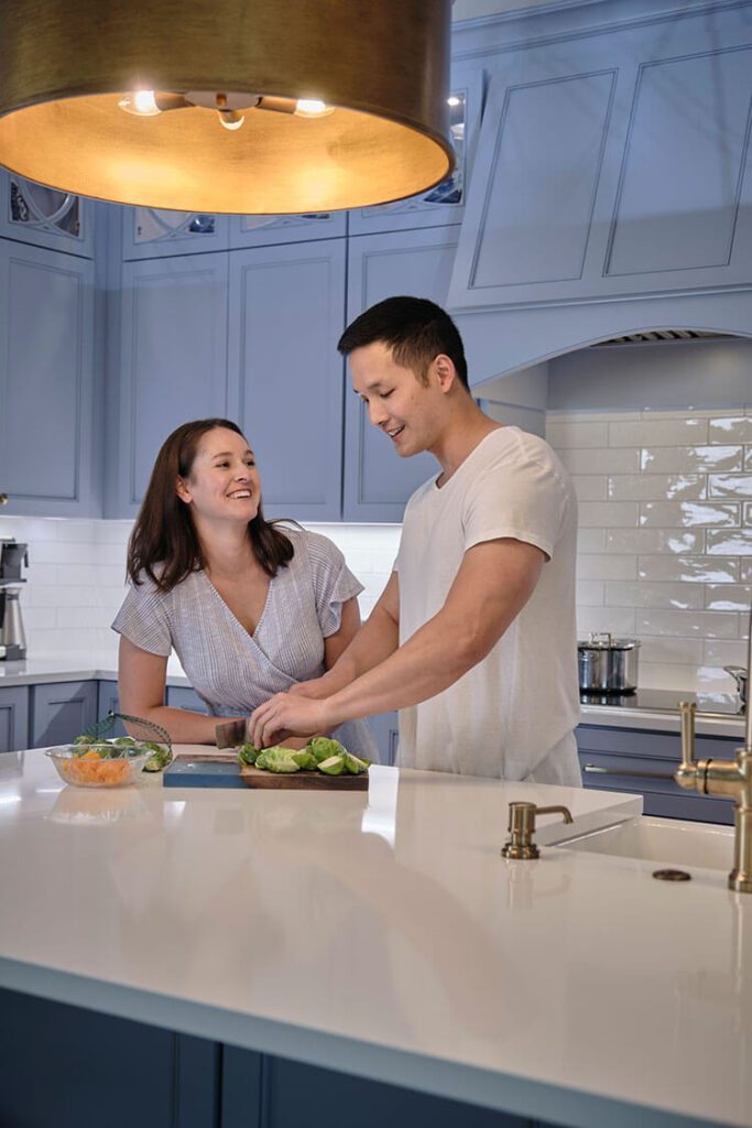 Couple in HVAC cooled kitchen cooking dinner