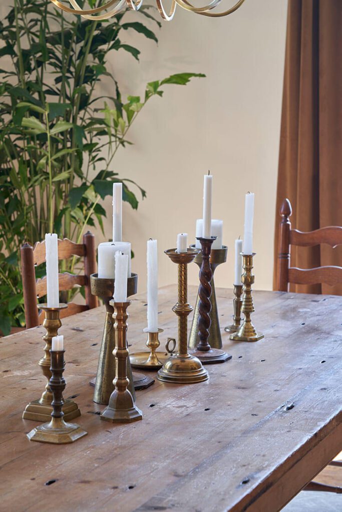 Tabletop with vintage brass candlesticks.