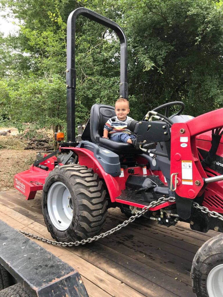 Bridger son Julian riding a tractor