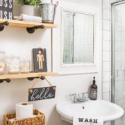 Bathroom with open shelves and pedestal sink