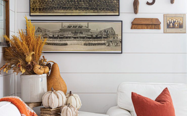 Wall with vintage military photographs lines up on the wall and pumpkins on table in front