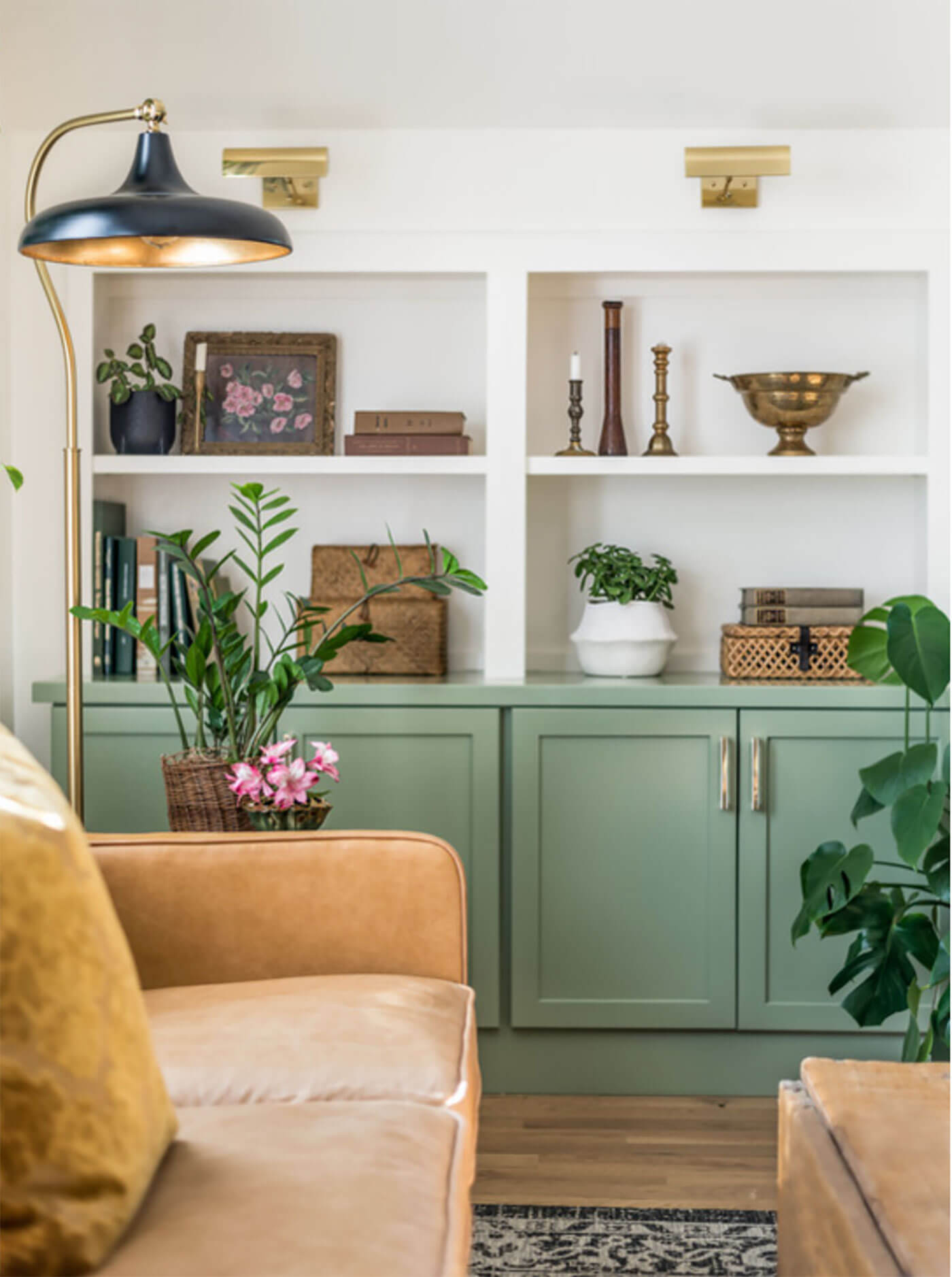 Living room with green painted cabinets and leather sofa for summer decor