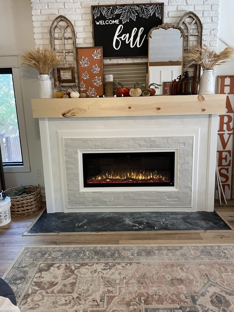 Author painted the remaining underlayment and trim on the front of the fireplace.