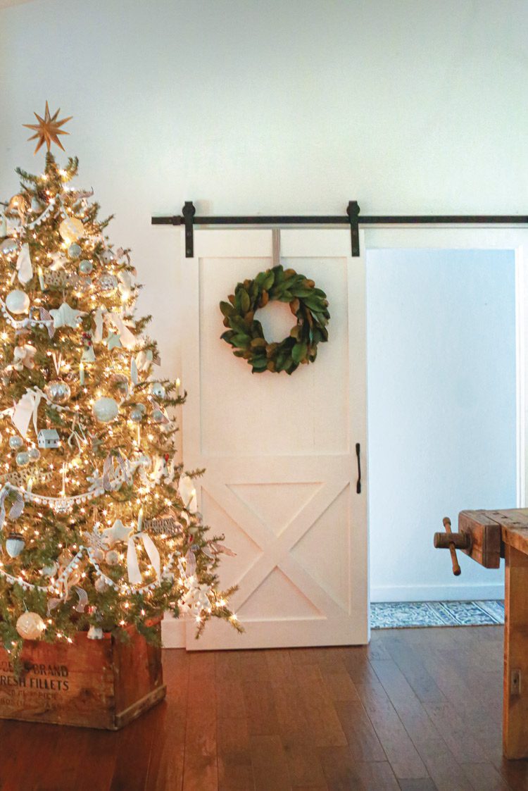 Christmas tree and wreath on interior sliding barn door