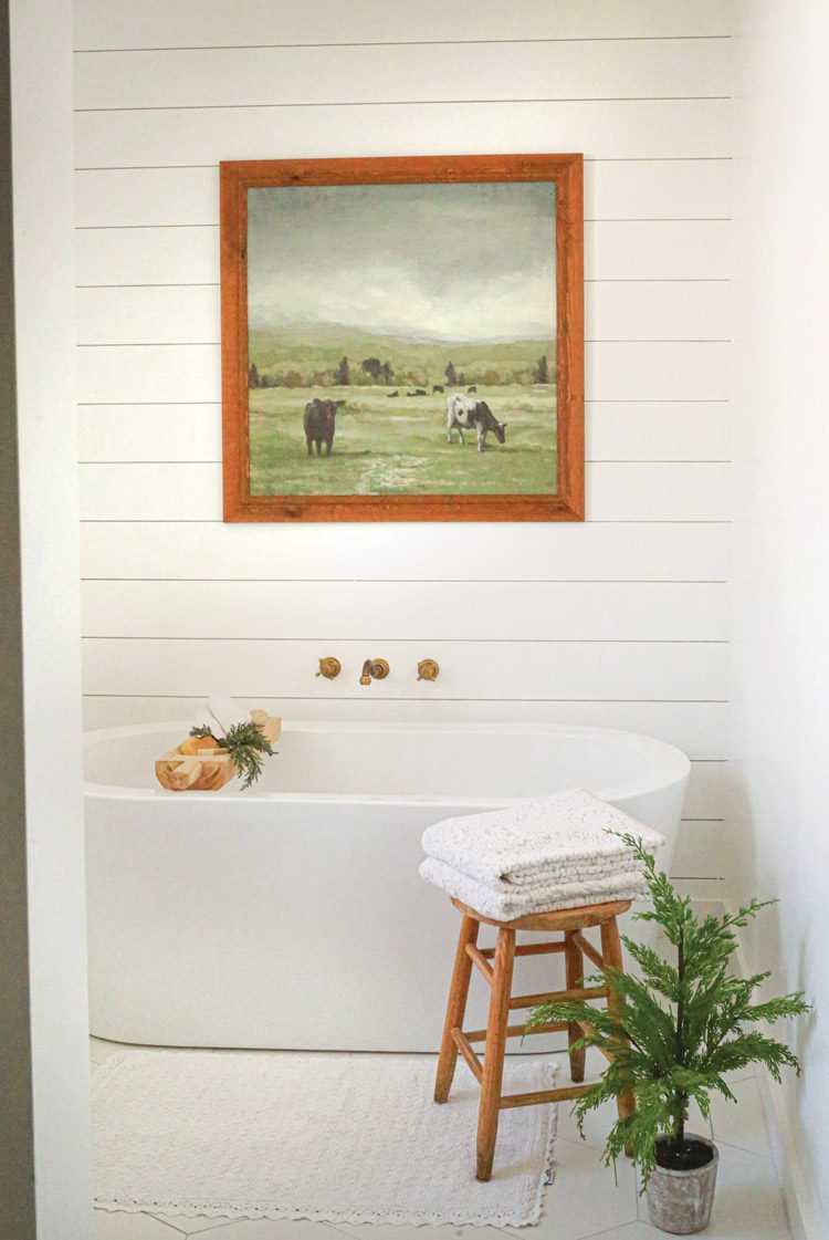 freestanding bathtub and shiplap in farmhouse bathroom