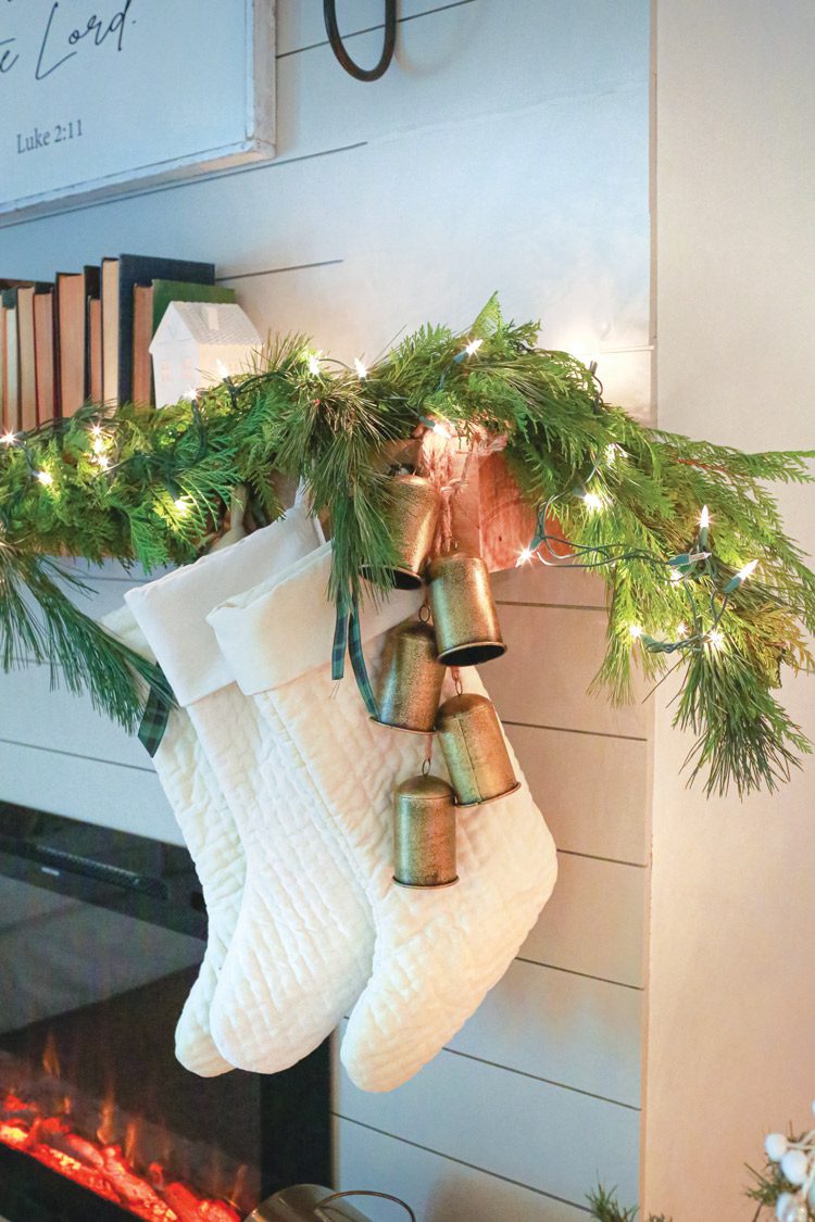 white stockings and fresh garland on mantel