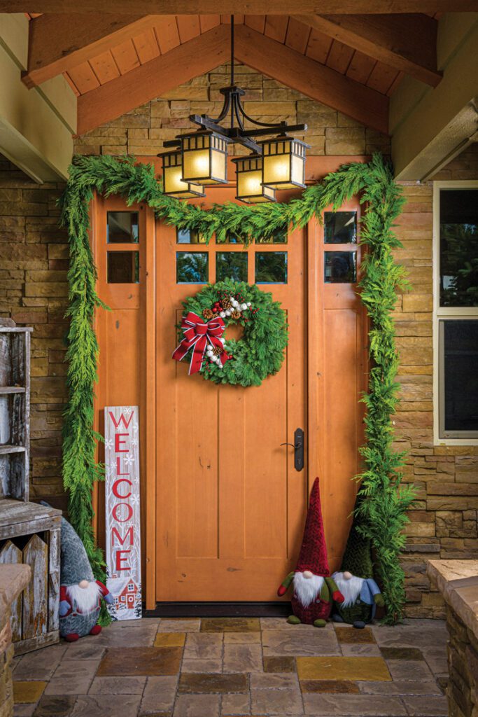 fresh Christmas garland and wreath on Arts and Crafts exterior doorway