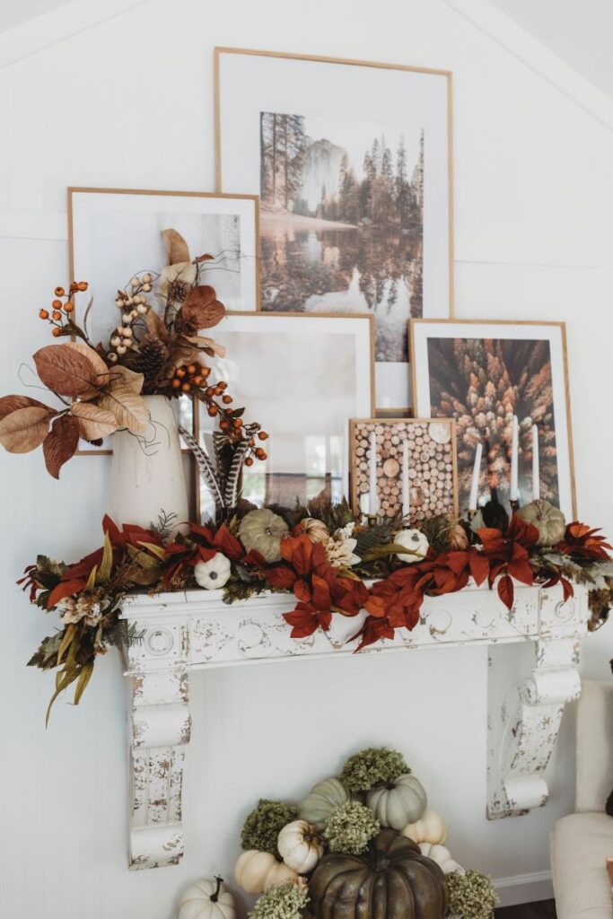 A painted white mantel is repurposed to hold five large wood frame filled with images of fall nature scenes.