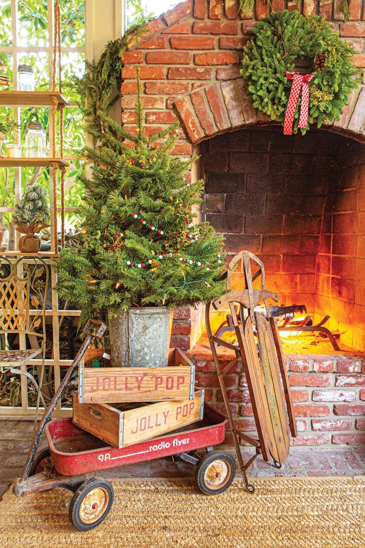 fresh wreath and garland and potted tree on fireplace