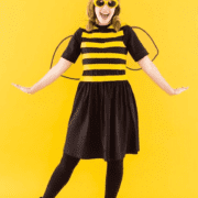Girl with bumble bee costume against yellow backdrop