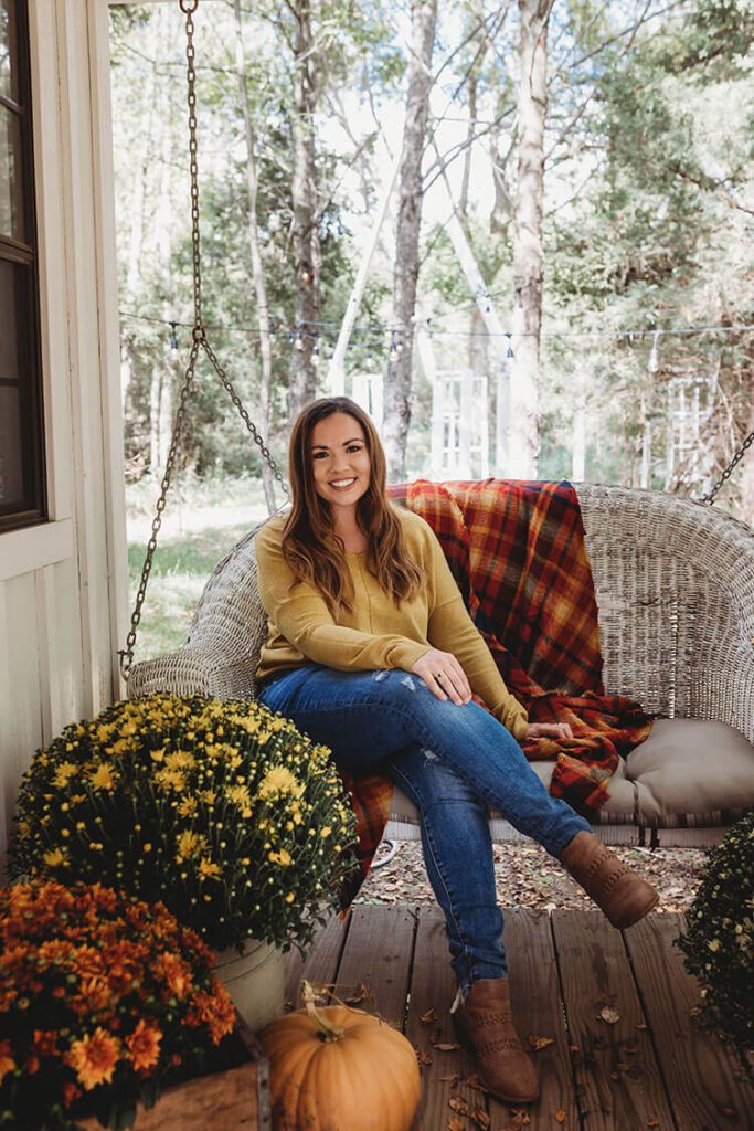 Blogger Holly Blain on front porch of she shed