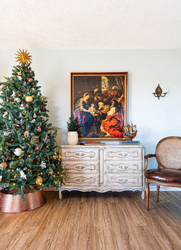Christmas tree with vintage painting next to it