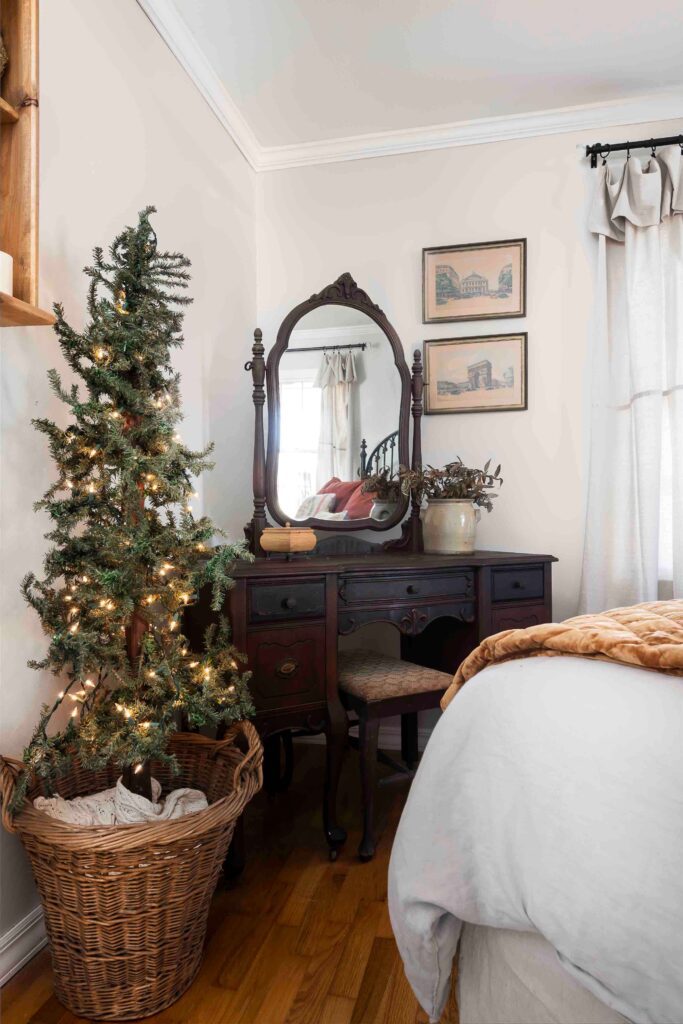 vanity with mirror in bedroom with Christmas tree in basket