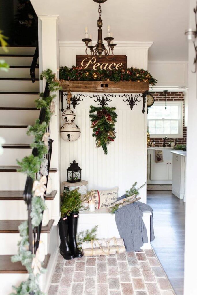 Upon crossing the threshold into Ahna's Pennsylvania Christmas home, a bunch of holiday boughs can be seen decorating the entryway's bench and hangers