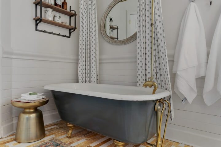 beadboard in bathroom with claw foot tub