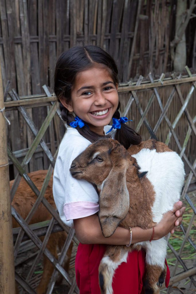 Young girl with goat from Heifer International