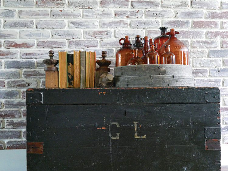 Glass bottles sitting on top of a black cabinet