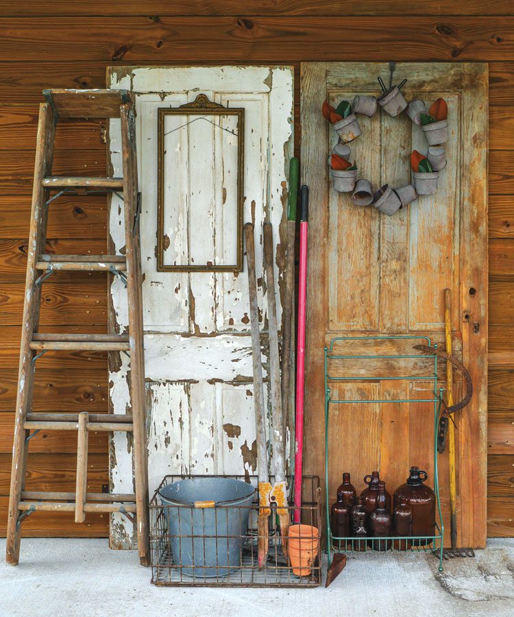 Glass bottles displayed with gardening supplies