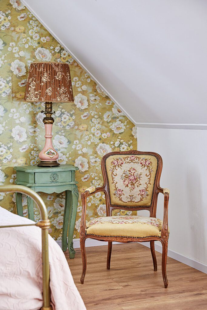 attic room with floral wallpaper