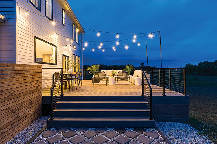 deck outdoor living room with string lights