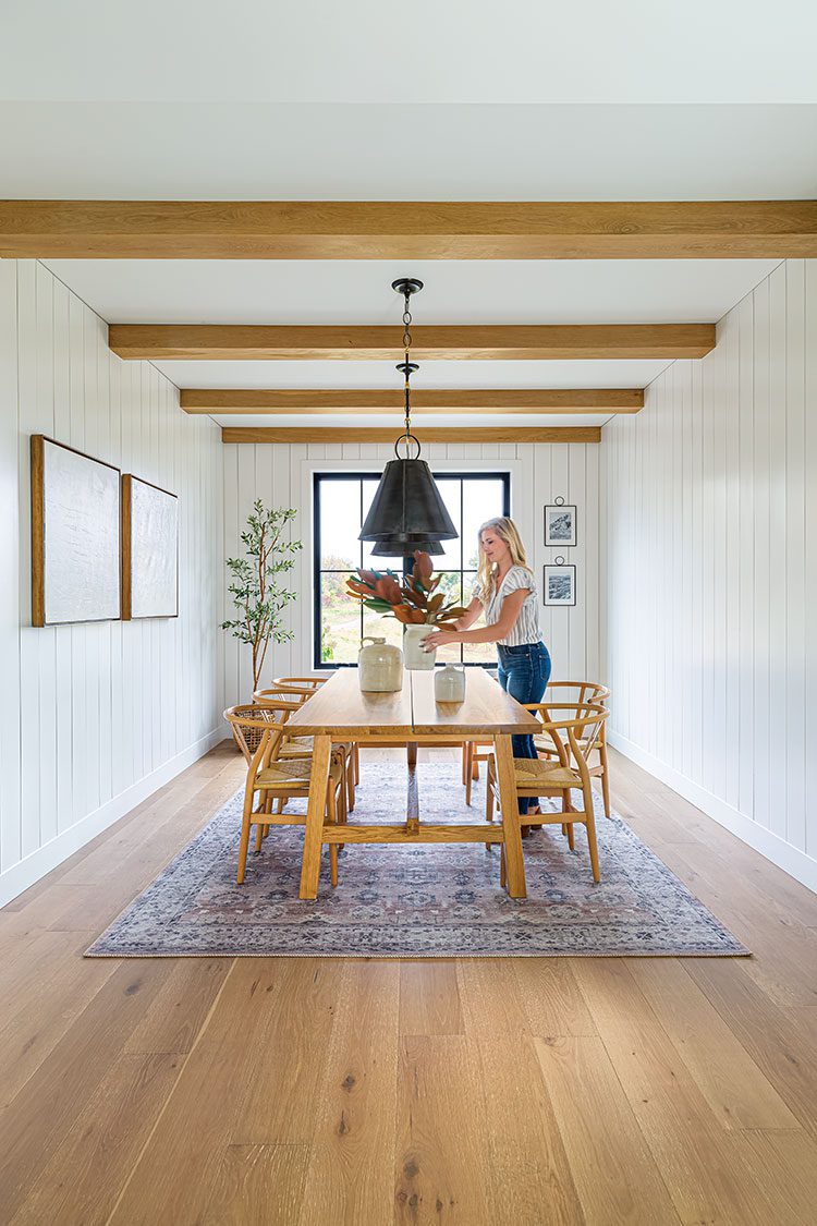 minnesota farmhouse dining room wooden beams and wishbone chairs