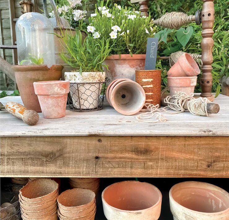 vintage terracotta pots displayed on outdoor potting table