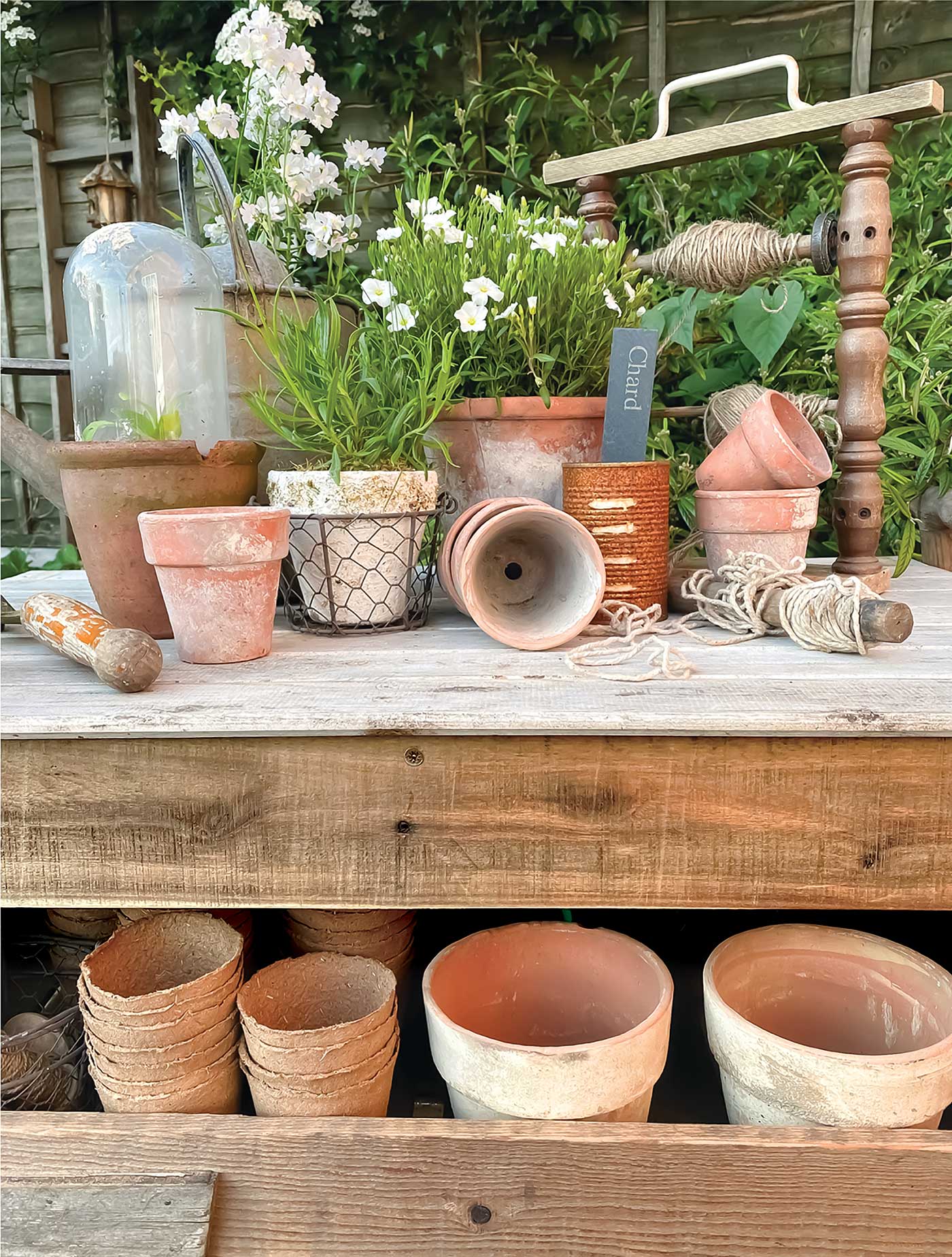 vintage terracotta pots displayed on outdoor potting table