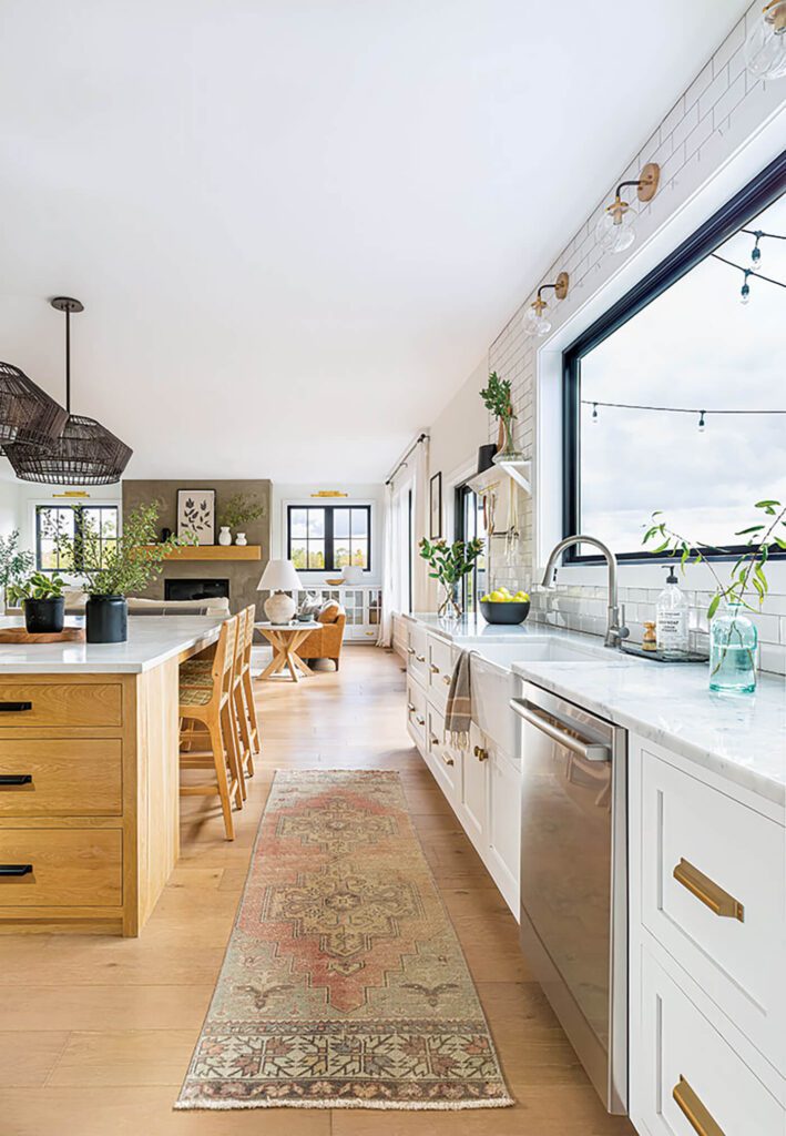 Farmhouse style kitchen with subway file, rug runner and island