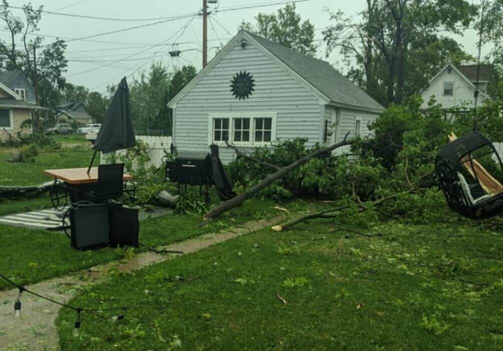 After a major storm, the home's backyard was covered in fallen trees and debris from the neighborhood.