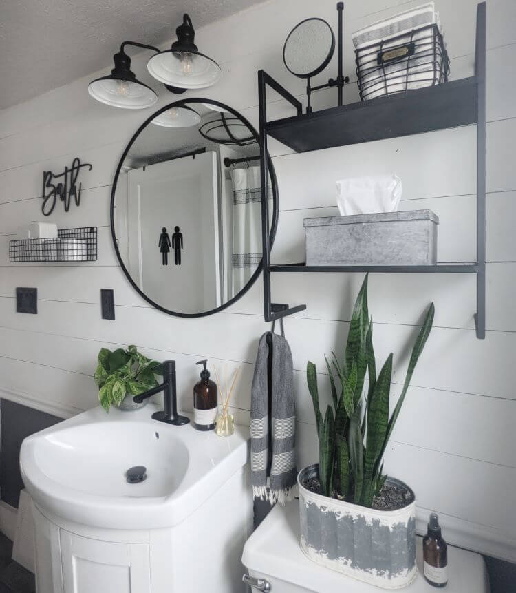 The bathroom has its own modern farmhouse update with white shiplap and industrial style shelving and hardware.