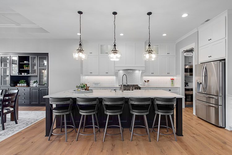 The open floor plan includes a massive white and black kitchen island
