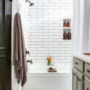 black and white floral mosaic tile in bathroom with white subway tile