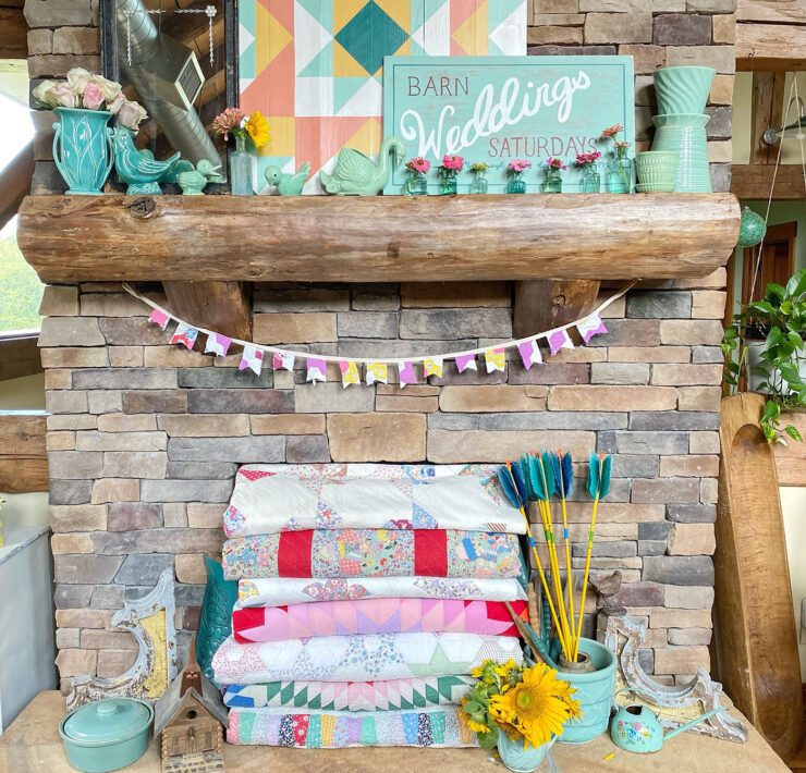 mantel with colorful quilts and pottery